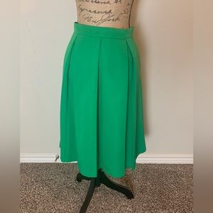 Green, large box pleat skirt.
